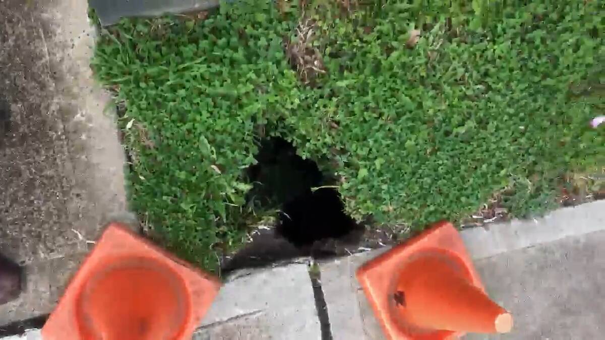 WHAT LIES BENEATH: The top of the sinkhole is just 30 centimetres across but it extends more than one metre below this Bentinck Street footpath.