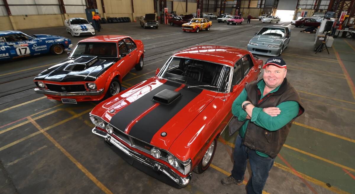 MUSCLE CARS: Lloyds Classic Car Auctions auctioneer Scott Burns with a 1971 Ford GTHO Phase 3 and a 1977 Holden Torana A9X Protoype.