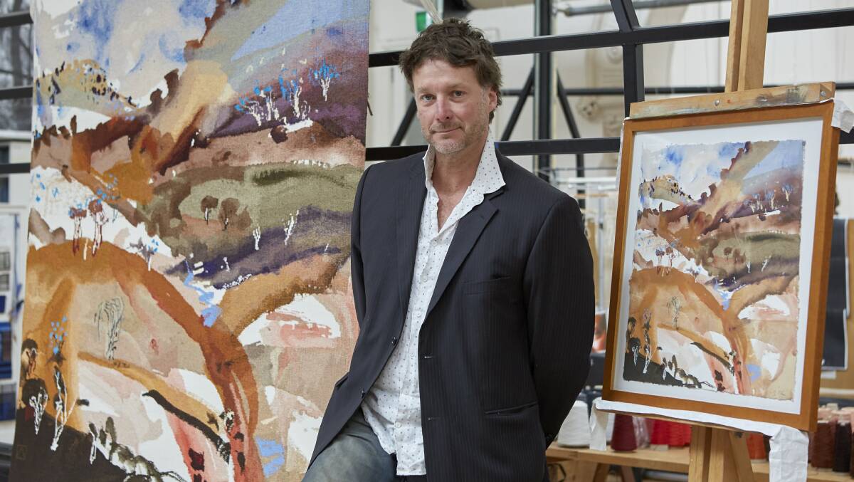 VETERAN: Artist Luke Sciberras at the Australian Tapestry Workshop with completed tapestry and Bridle Track, Hill End watercolour, October 2019. Photo: SUPPLIED