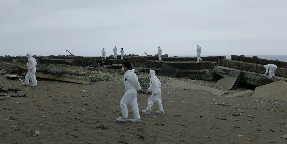 EERIE: Bathurst delegates in protective clothing take a sombre walk in 2016 through the desolate landscape left behind by the Fukushima nuclear disaster on the outskirts of Bathurst’s sister city of Ohkuma, Japan. Photo: WARREN AUBIN 042116radioactive1