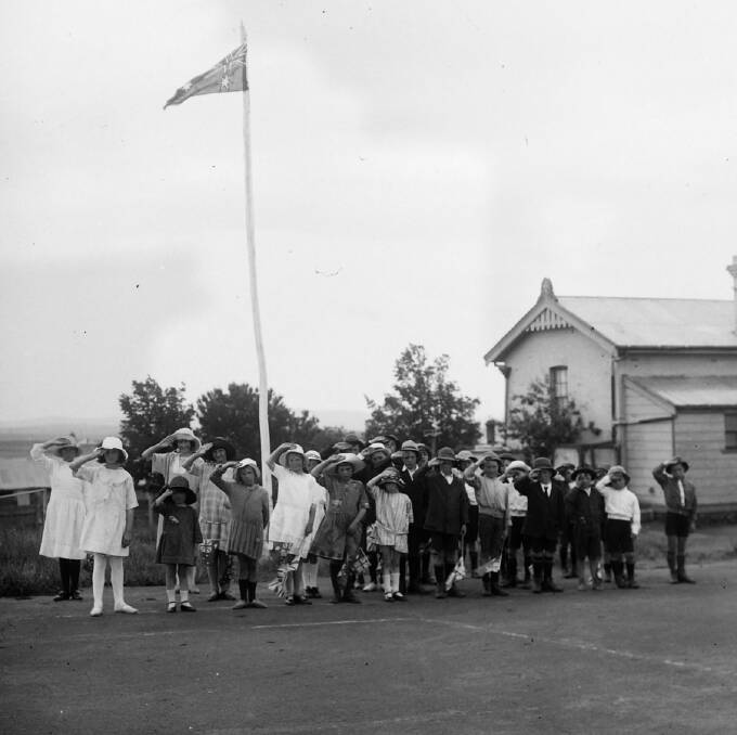 KING AND COUNTRY: Raglan Public School students saluting the flag in November 1924. Photo: SUPPLIED