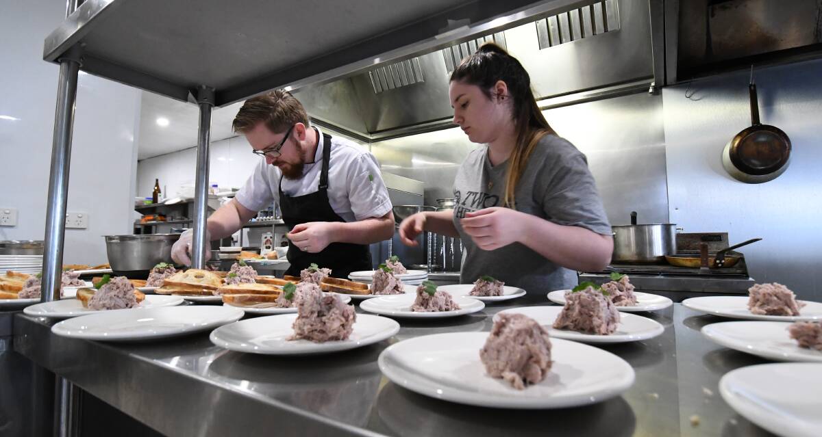 SNAPSHOT: Michael Brill with Amy Squires preparing plates of duck rillettes at Two Heads Brewing the Winter Winery Tour on Sunday. 