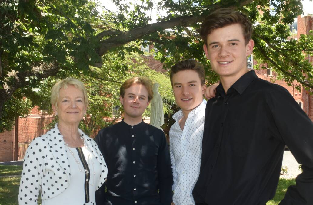 THRILLED: Retiring St Stanislaus' head of college Dr Anne Wenham with former students Oliver O'Toole, Jerome Arrow and Dominic McCrossin celebrating some outstanding results in the 2017 HSC. Photo: FILE