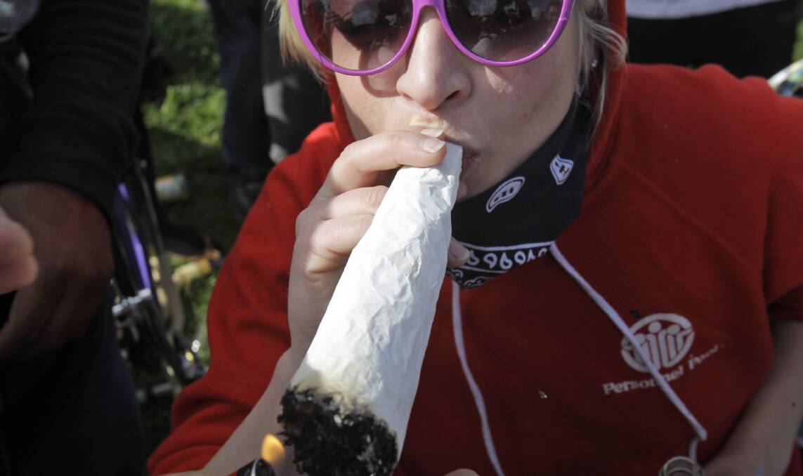 GREEN, GREEN GRASS: A woman lights a large marijuana joint at the Golden Gate Park in San Francisco. California this year became the largest state in the US to offer legal recreational marijuana sales. Photo: FILE
