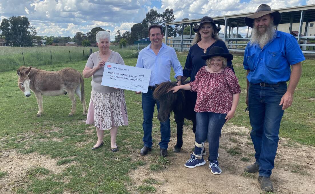 RIDE ON: Bathurst MP Paul Toole at the Riding for the Disabled headquarters in Bathurst with local president Suzanne McDonagh, left, Melinda, Darren and Zoe Gavin, front. Photo: SUPPLIED