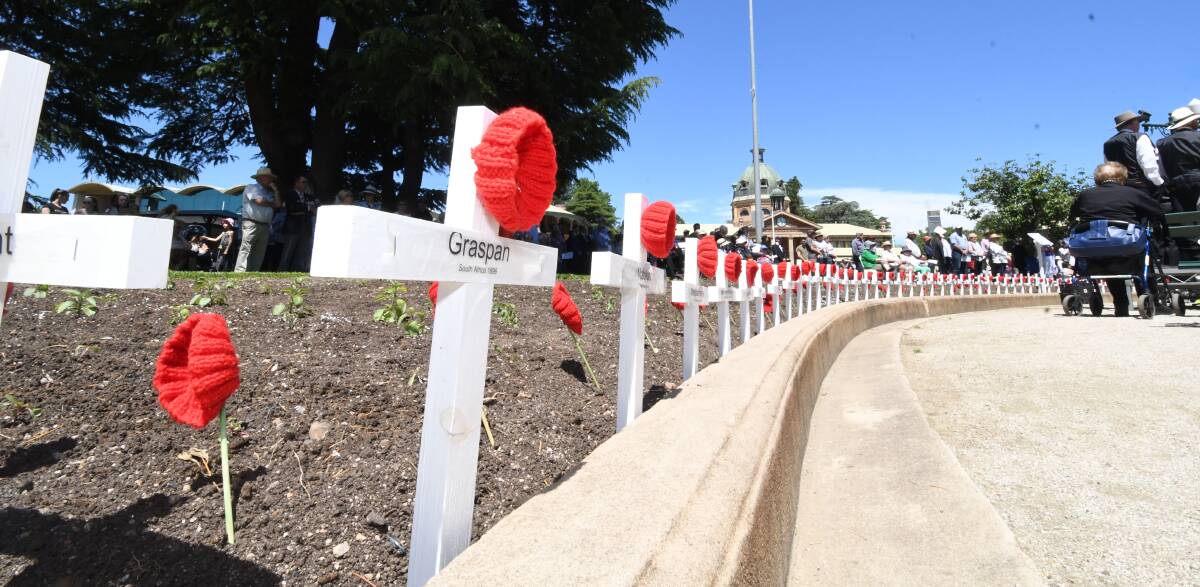 LEST WE FORGET: Small crosses and hand-knitted poppies to honour the fallen during Sunday's Remembrance Day commemoration.