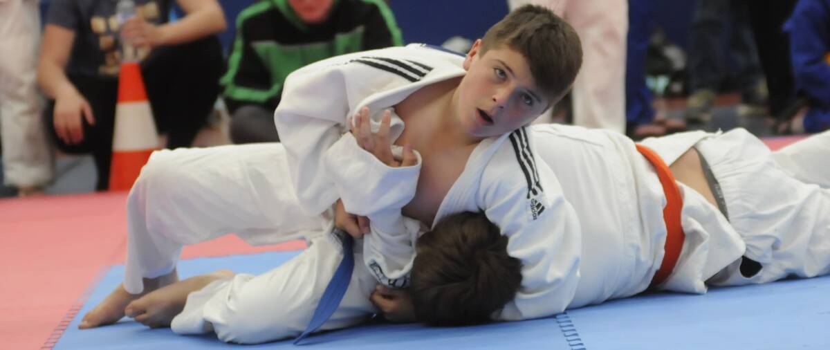 GET A GRIP: Nat Lindsay from Wellington puts a hold on Grady Simons from Blacktown PCYC during a Bathurst PCYC judo event on Sunday. 