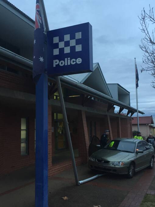 CRASH SCENE: The scene at the Bathurst Police Station on Friday evening, when the Holden Commodore crashed into the flag pole.