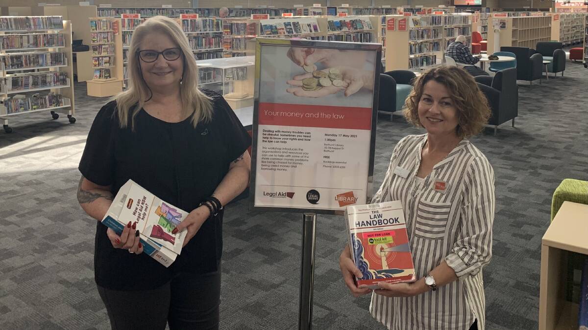 BOOK IT IN: Bathurst Library assistants Sarah Jones and Belinda Vanderhel preparing for Library and Information Week and Law Week events. Photo: SUPPLIED