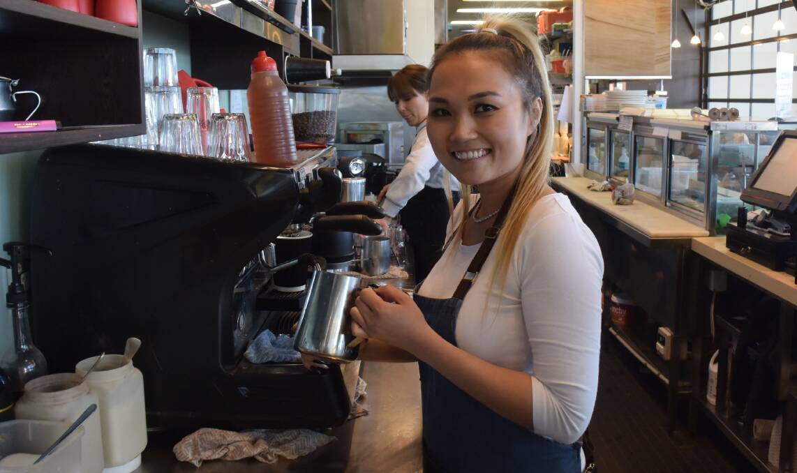 BEAN THERE: Barista Nicky Ly back at work at Venue Cafe after placing second in the Grinders Coffee state competition. Photo: ETHAN LAW