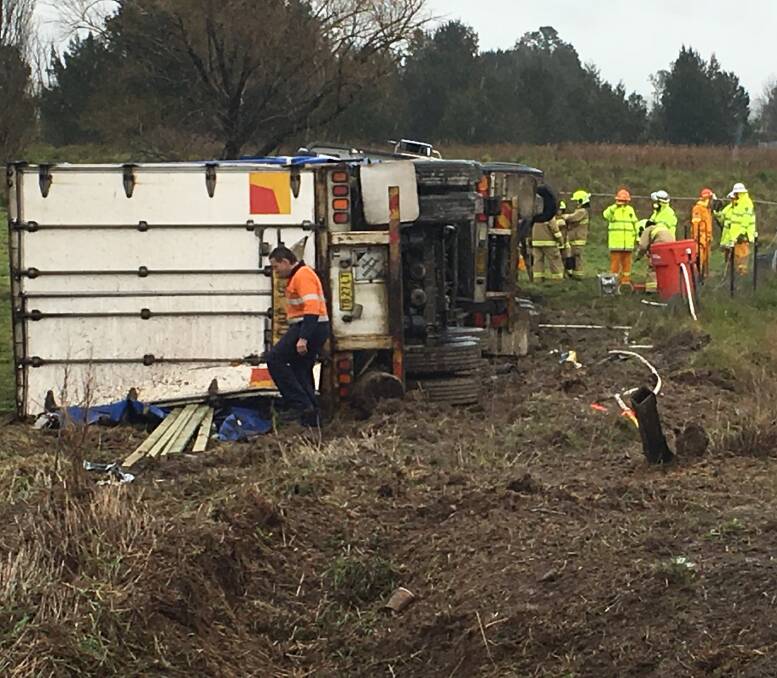 ROLL-OVER: Emergency services on the scene of a B-double truck crash on the O'Connell Road on Wednesday. Photo: DAVID CARROLL 083116crash