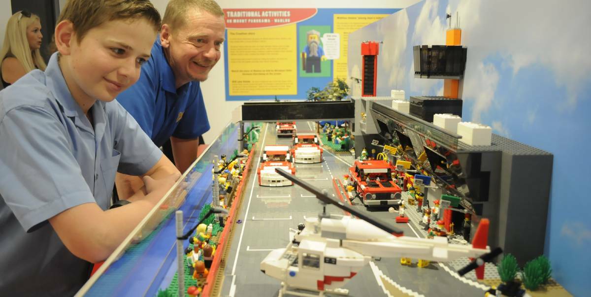 BRICK BY BRICK: Will Starkey and his dad, Pete, having a close look at the Pit Straight model made of Lego at the Bathurst Regional Art Gallery in 2016.
