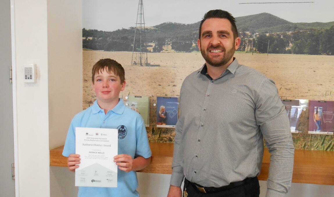 PRESENTATION: Perthville Public School student Patrick Wells and Nathan Shaw from Newcastle Permanent. Photo: SUPPLIED