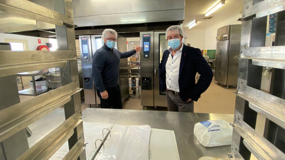 MEETING DEMAND: Colin Hope from the Bathurst-based Meals on Wheels service shows Member for Bathurst Paul Toole around the Bathurst kitchen. Photo: SUPPLIED