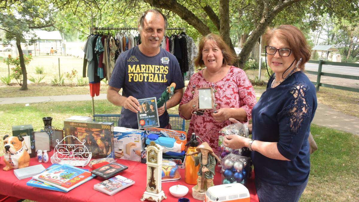 LOTS ON OFFER: Tony Thorpe, Moira Spinazza and Julie Bartlett at a previous $1 op shop sale. It's back this weekend. Photo: RACHEL CHAMBERLAIN