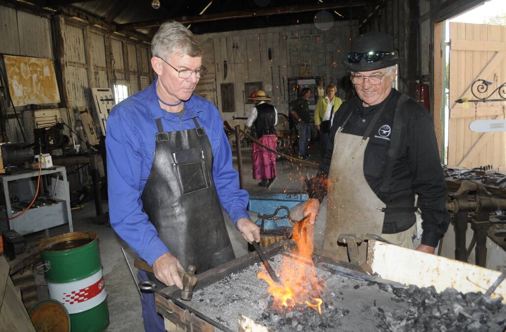 CRAFTSMANSHIP: Blacksmiths Tom Miller (from Newbridge) and Steve Evans giving a practical demonstration at Bathurst Agricultural Research Station during the 2017 Heritage Trades Trail weekend last year. Photo: CHRIS SEABROOK