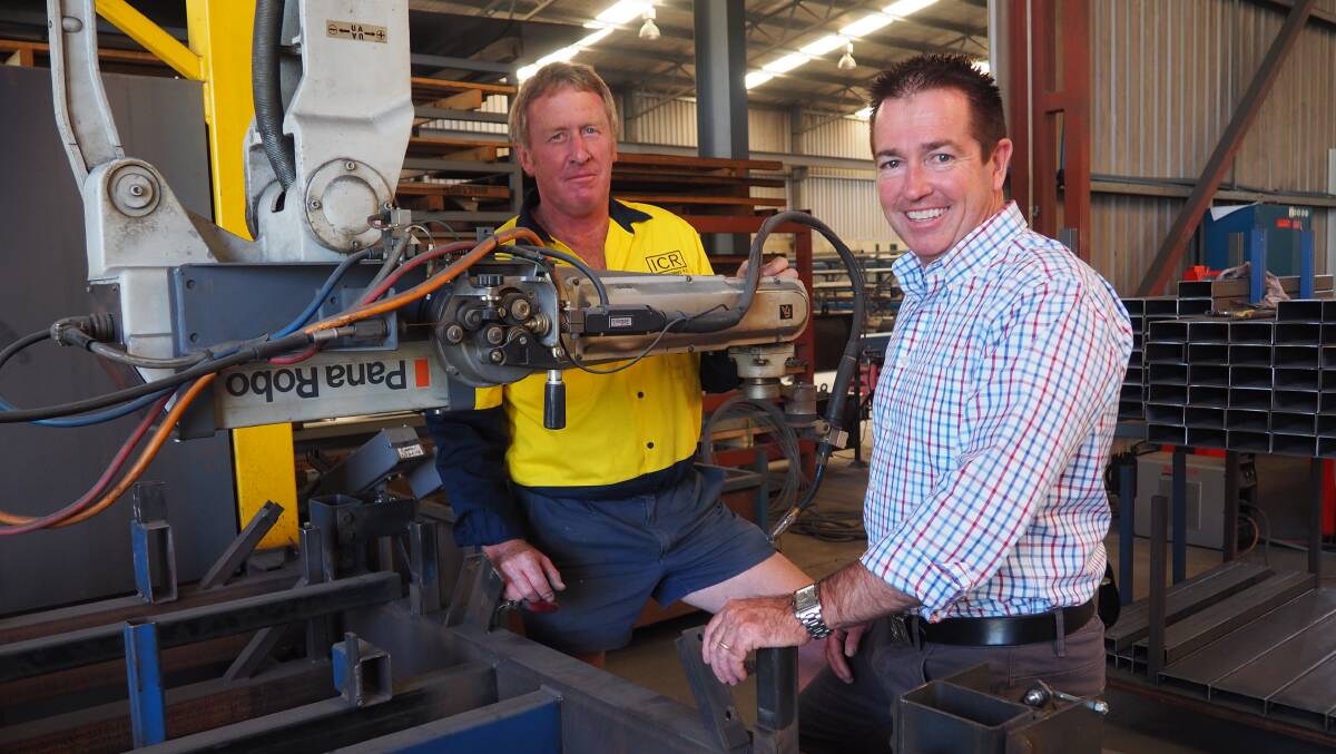 DOWN TO BUSINESS: Bathurst MP Paul Toole with Ian Reeks at ICR Engineering in Blayney with some of the state-of-the-art equipment that will be used to make the firefighting units for the National Parks and Wildlife Service. Photo: SUPPLIED