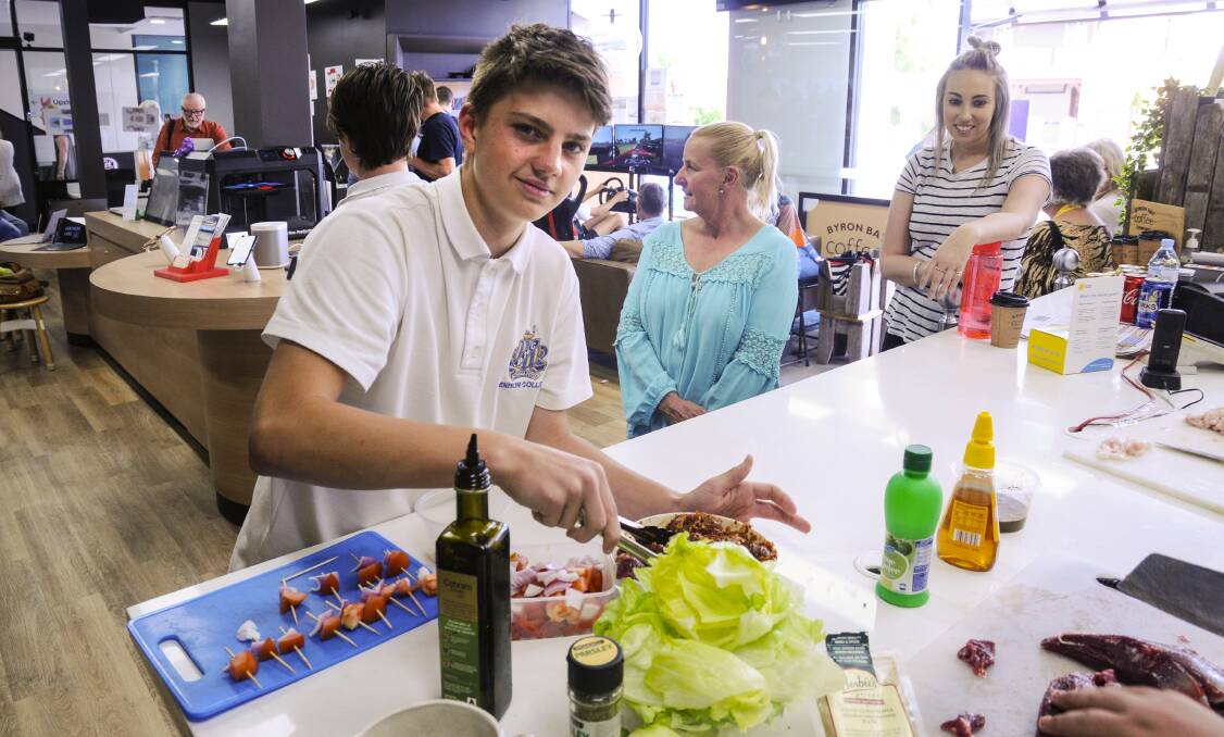 Liam Barney from Bathurst High School prepares kangaroo skewers in preparation for the opening. Photo: VINCE LOVECCHIO