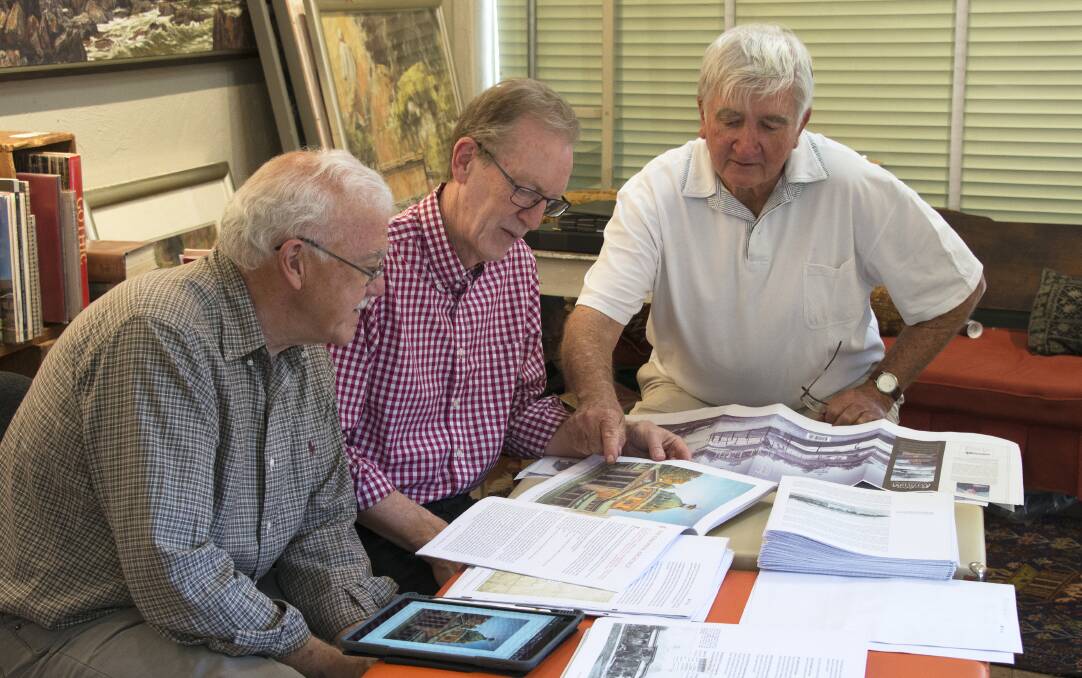 FINAL DRAFT: Author Graham Lupp, graphic designer Tony O’Neill and copy editor John Payne check the final proofs of Building Bathurst 1815-1915. Photo: SUPPLIED