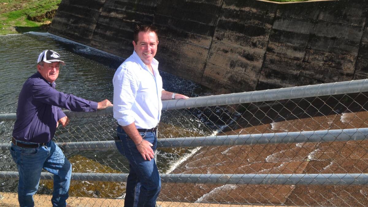 GREAT NEWS: Mayor Bobby Bourke and Bathurst MP Paul Toole watching water flow down the spillway at Ben Chifley Dam on Monday morning. Photo: MURRAY NICHOLLS