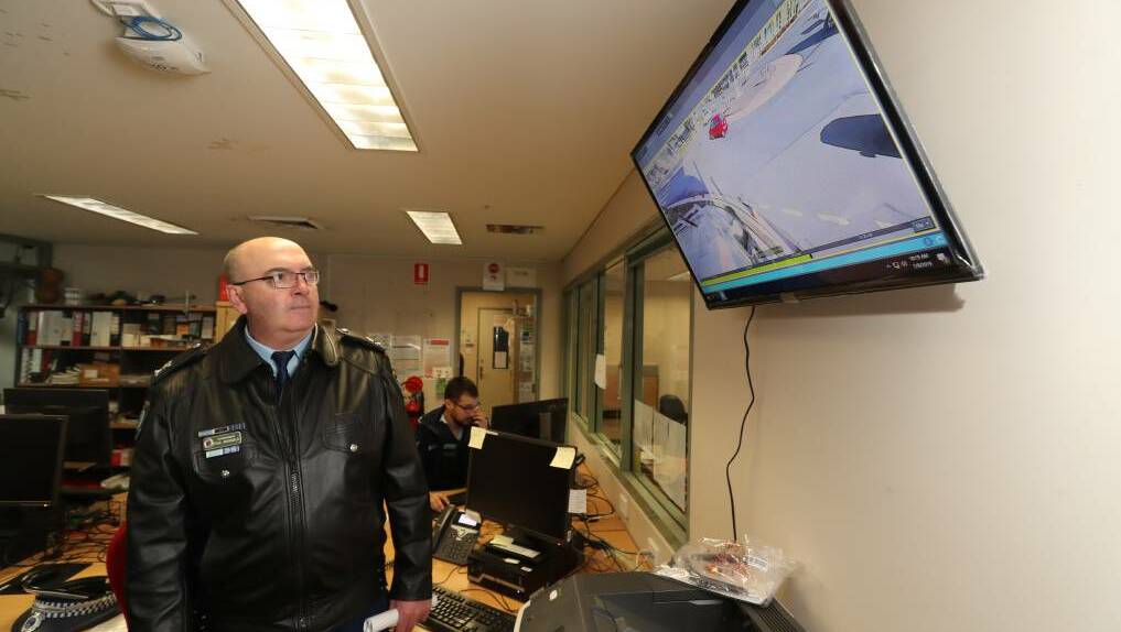EYE ON CRIME: Former Chifley Police District Superintendent Paul McDonald looks over one of the screens during the first stage of the CCTV rollout last July. Photo: PHIL BLATCH 070919pbcctv1