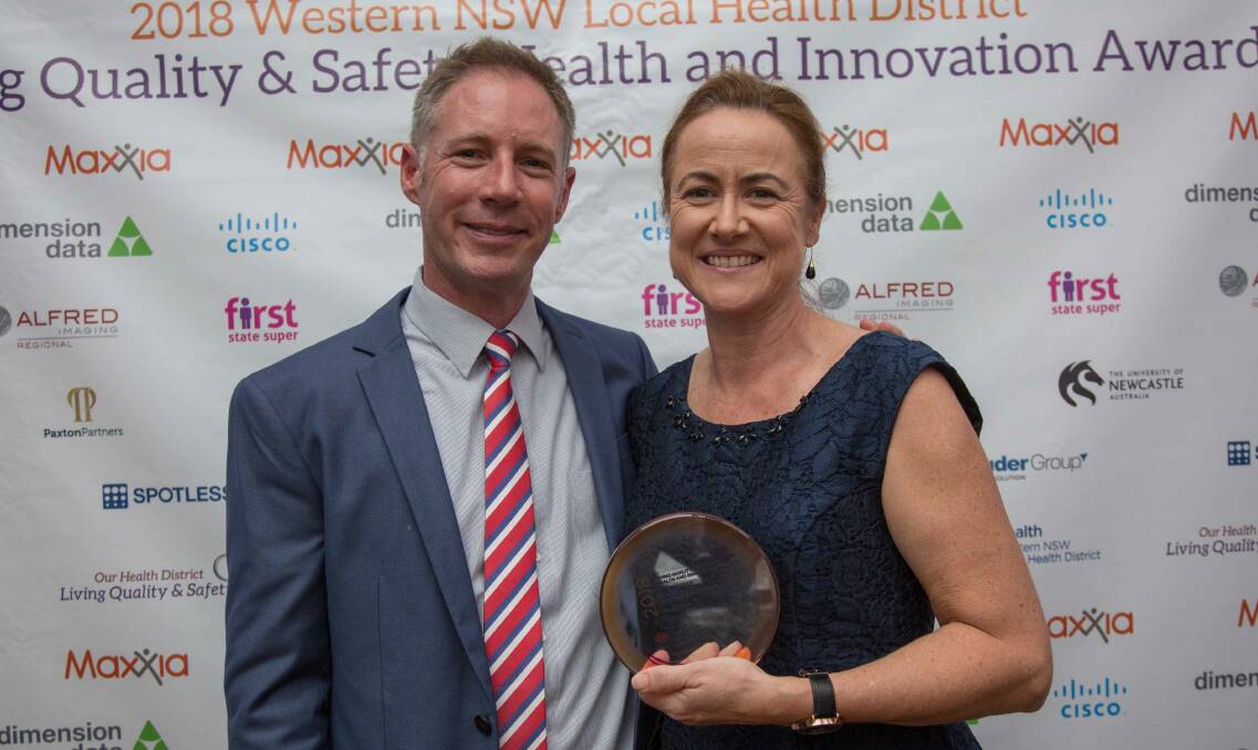 AWARD WINNER: Western NSW Local Health District CEO Scott McLachlan congratulates Bathurst's Karen Beattie in Dubbo on Thursday night. Photo: SUPPLIED