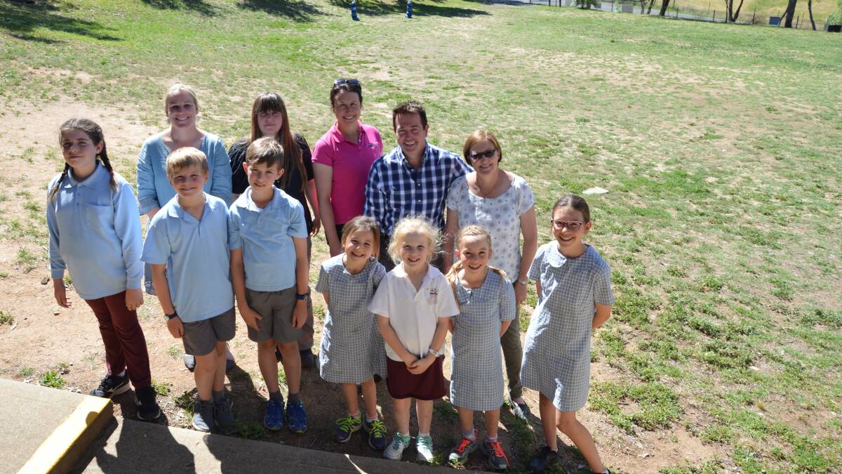 MAKEOVER: Bathurst MP Paul Toole at O’Connell Public School with principal Trish Forsyth (right), parents Sally Webb, Nicola Mason, Sarah Bird and students celebrating funding to give the front sports oval a badly needed upgrade. Photo: SUPPLIED