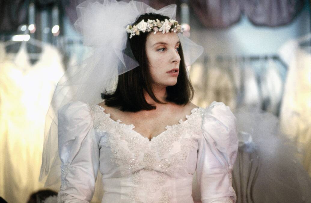 I DO, I DO, I DO, I DO, I DO: Toni Collette as Muriel trying on a wedding dress in the 1994 film, Muriel's Wedding. Photo: ROBERT McFARLANE
