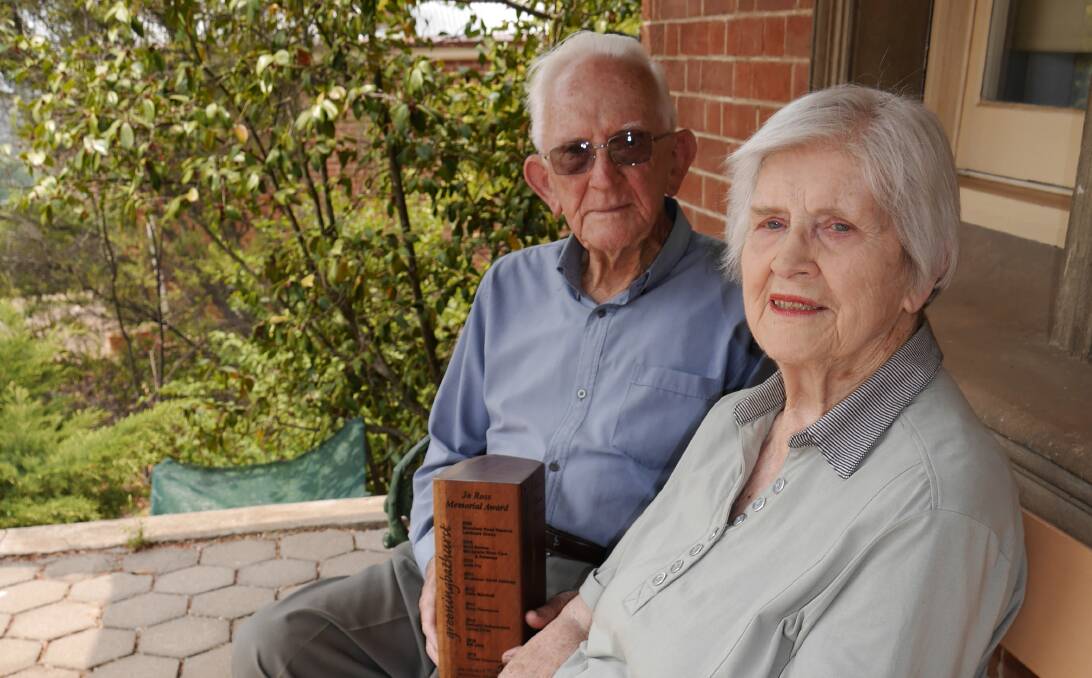 GREEN MACHINE: Norah and Daryl Taylor on their front porch in Bathurst, pictured with the perpetual Jo Ross Award they won in 2019. Photo: SUPPLIED