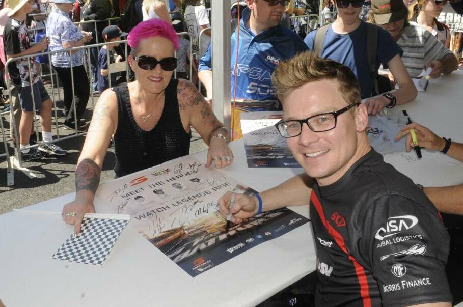RACE FANS: Tracy Cawte from Hamilton, New Zealand, pictured with Supercars driver Jack Perkins at the 2017 driver signing. Photo: CHRIS SEABROOK 100417cdrivrs1