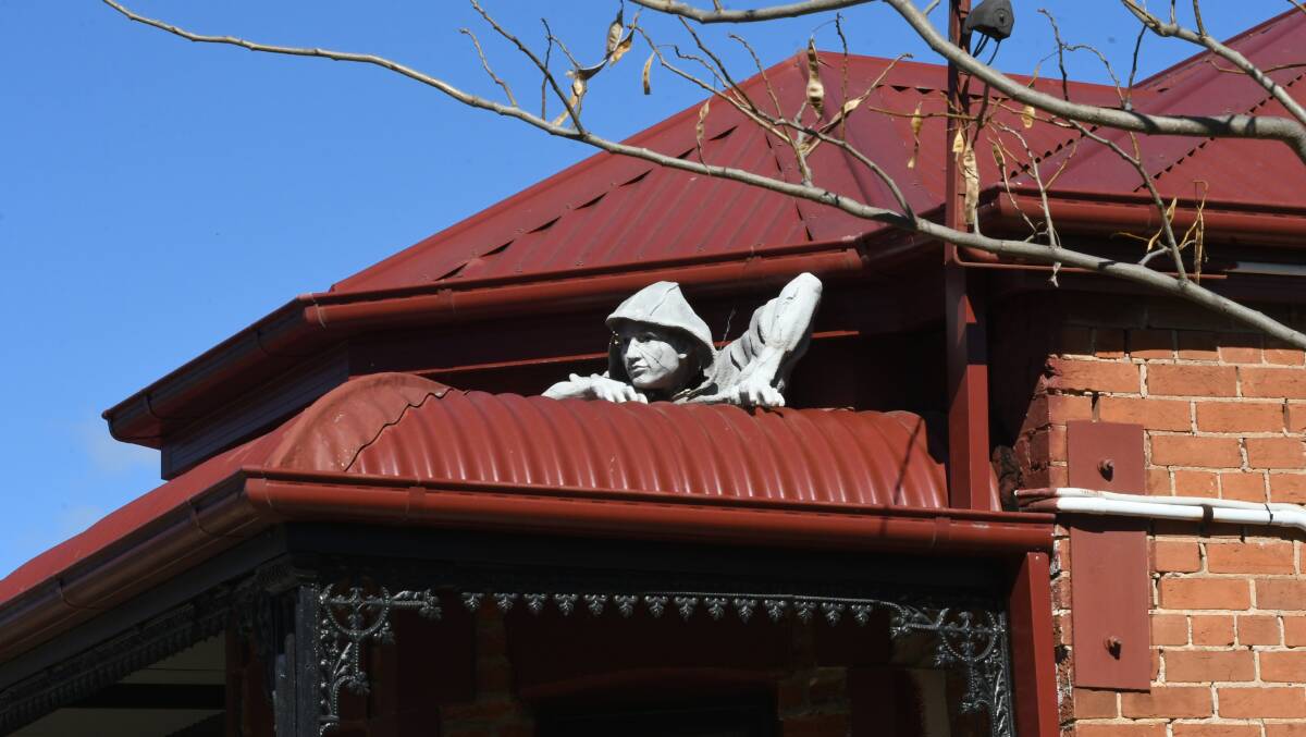 KEEPING WATCH: Spotted in Morrisset Street on Tuesday was this unusual figure adorning a bullnose veranda. Photo: CHRIS SEABROOK 082019csnap1