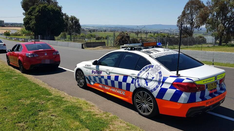 FAST LANE: Police stopped a speeding red Holden SS Commodore on Conrod Straight on Mount Panorama on Saturday morning. Photo: NSW POLICE