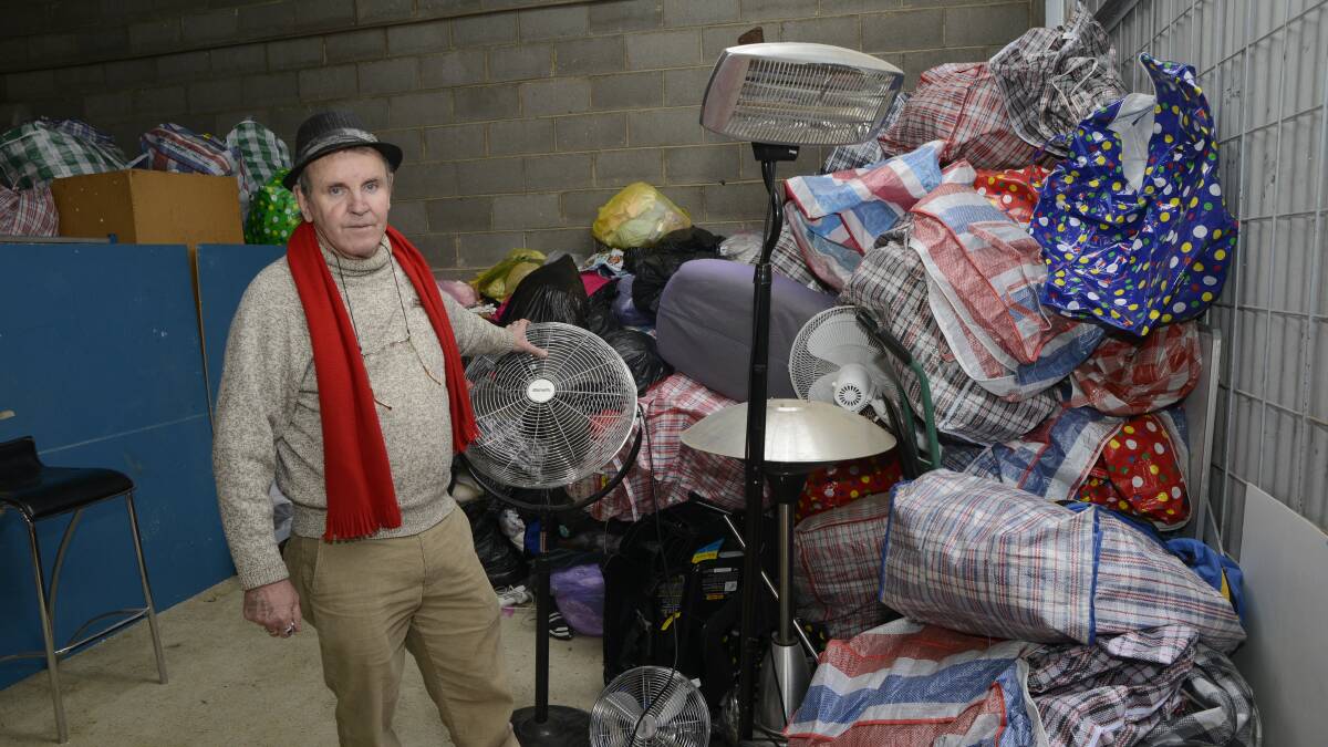 RUNNING LOW: Salvation Army store manager Stephen Barrott with clothes to be handed out to needy people this week. Demand for the Salvo's services got so high two weeks ago that they had to source more clothes from Sydney stores. Photo: PHILL MURRAY 062716psallies1
