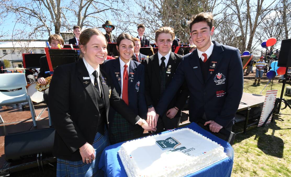 SLICE OF HISTORY: Scots and All Saints' school leaders Elizabeth Coles, Georgia Poole, Ben Dickenson and Charlie O'Neill at Sunday's spring fair. Photo: CHRIS SEABROOK 090918claunch1