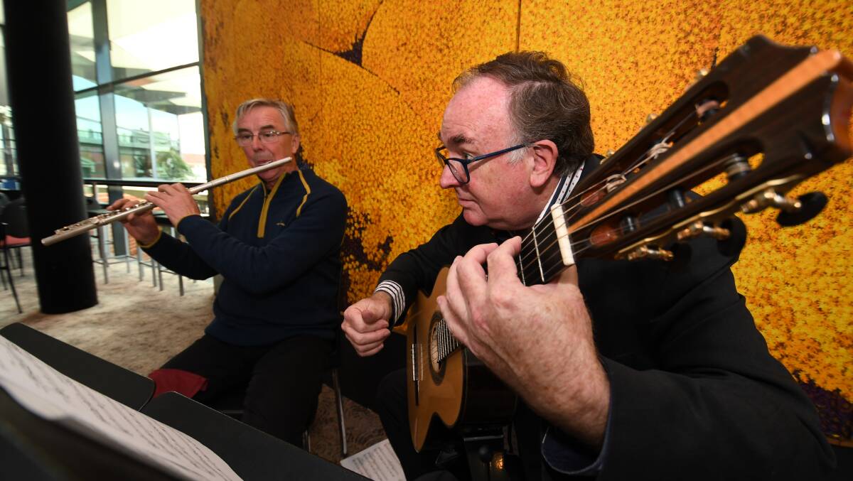 BACKGROUND MUSIC: Phil Braithwaite and Andrew French-Northam from Mitchell Conservatorium at the Artstate launch on Monday. Photo: CHRIS SEABROOK