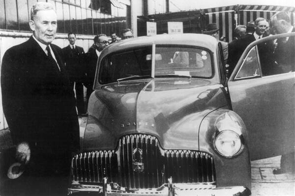 SPECIAL FX: Bathurst's favourite son, former Prime Minister Ben Chifley, launches Australias first motor car, the Holden 48-215, as it rolls off the production line on November 29, 1948