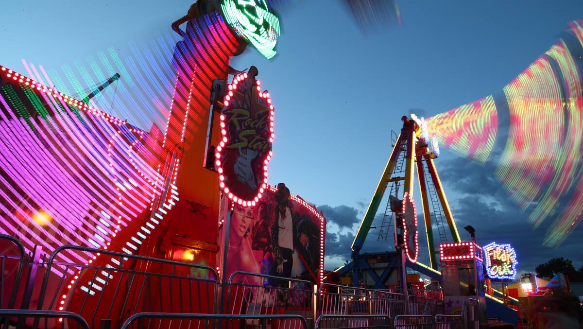 COLOUR AND MOVEMENT: A spectacular view of Sideshow Alley on Friday night. Photo: PHIL BLATCH