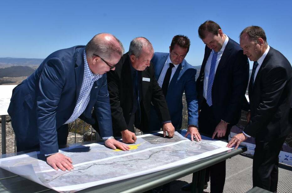 PLAN: Roads and Maritime Services western region director Alistair Lunn, Bathurst mayor Bobby Bourke, Member for Bathurst Paul Toole, Nationals MLC Sam Farraway and Orange City Council's technical services director Wayne Gailey look over plans for the Great Western Highway upgrade.