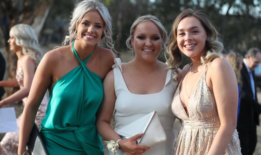 HAVING A BALL: Tatum O'Shea, Monique O'Shannessy and Leah Muller at the MacKillop College Year 12 graduation ceremony at Bathurst Goldfields last year. The Year 12 Class of 2020 now has the green light to hold their own grad balls. 111619pbmck4