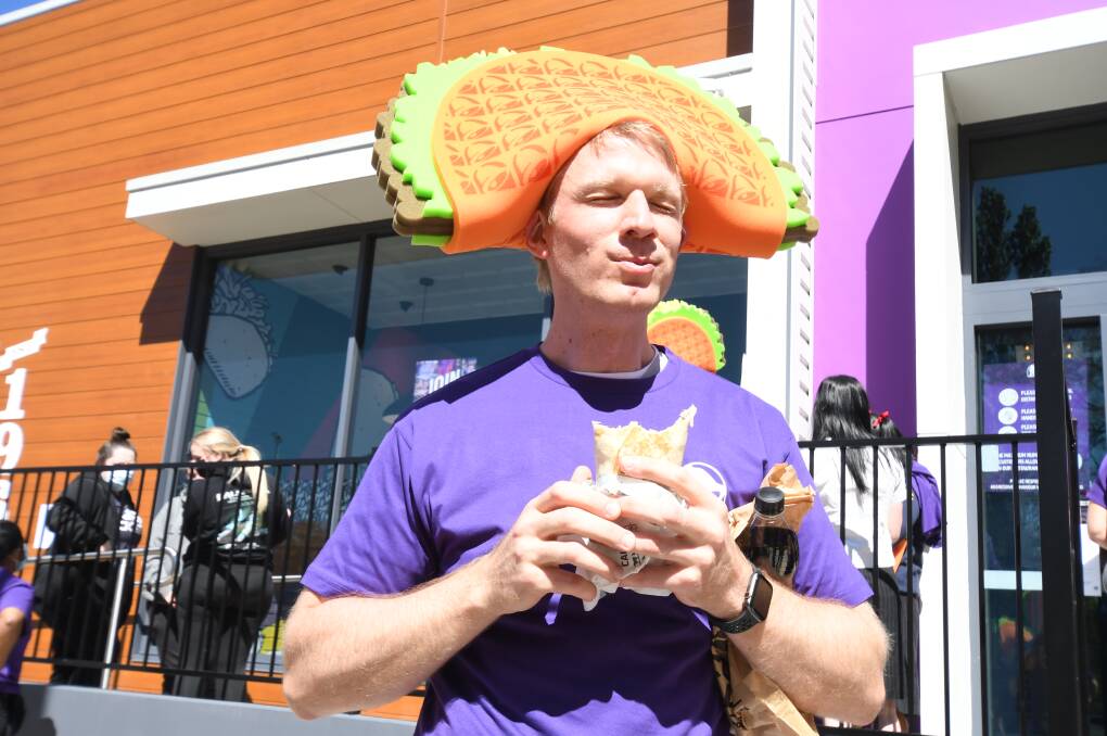 WORTH THE WAIT: Gareth Gribble and his mates arrived arrived half an hour before the official opening of the new Taco Bell store to be the first in line. Photo: JUDE KEOGH