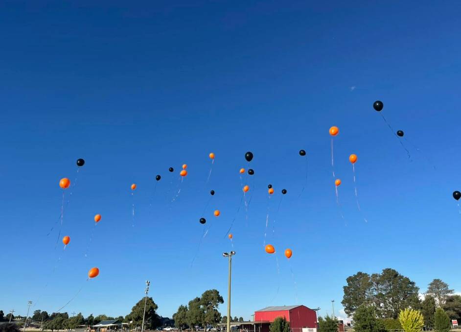 Caleb's AFL club mates at the Orange Tigers released black and orange balloons for him this week. Photo: FACEBOOK.