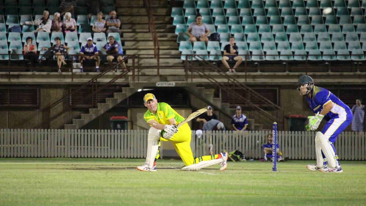 HATS!: Dave Neil batting in a cap on Friday night. Photo: MAX STAINKAMPH