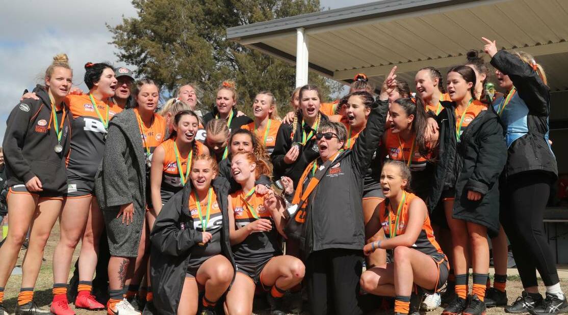 ROARING: Liz Kennedy and her Giants after winning the AFL Central West premiership. Photo: CHRIS SEABROOK