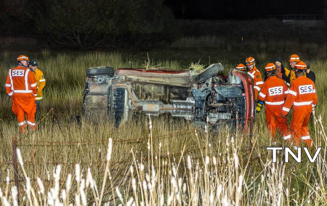 HARD AT WORK: NSW Rural Fire Service crews attending to woman on Newbridge Road. Photo: TROY PEARSON/TOP NOTCH VIDEO