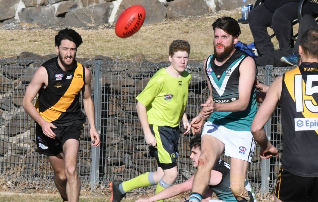 ON THE WAY BACK: Bushrangers' Tim Hunter kicks clear of Tigers' Jaxon Mumme. The Bushrangers, Tigers and their fellow CWAFL clubs have been cleared to return to training. Photo: CHRIS SEABROOK