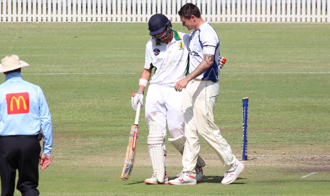 TOUCHING MOMENT: Ed Morrish consoles Bathurst's Ben Mitchell after sending his bails flying as he tried to bring up his century and a win with a six. Photo: MAX STAINKAMPH
