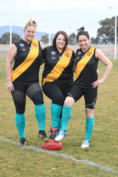 SISTERS IN ARMS: Cat Lee, Renee Cullis and Kristen Hunter all played alongside Katrina Hobby in the Tigerette's first season in 2015. Photo: JUDE KEOGH 0808jkafl1