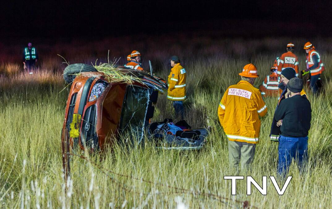 THE SCENE: NSW Rural Fire Service personnel at the site of Wednesday night's crash. Photo: TROY PEARSON/TOP NOTCH VIDEO