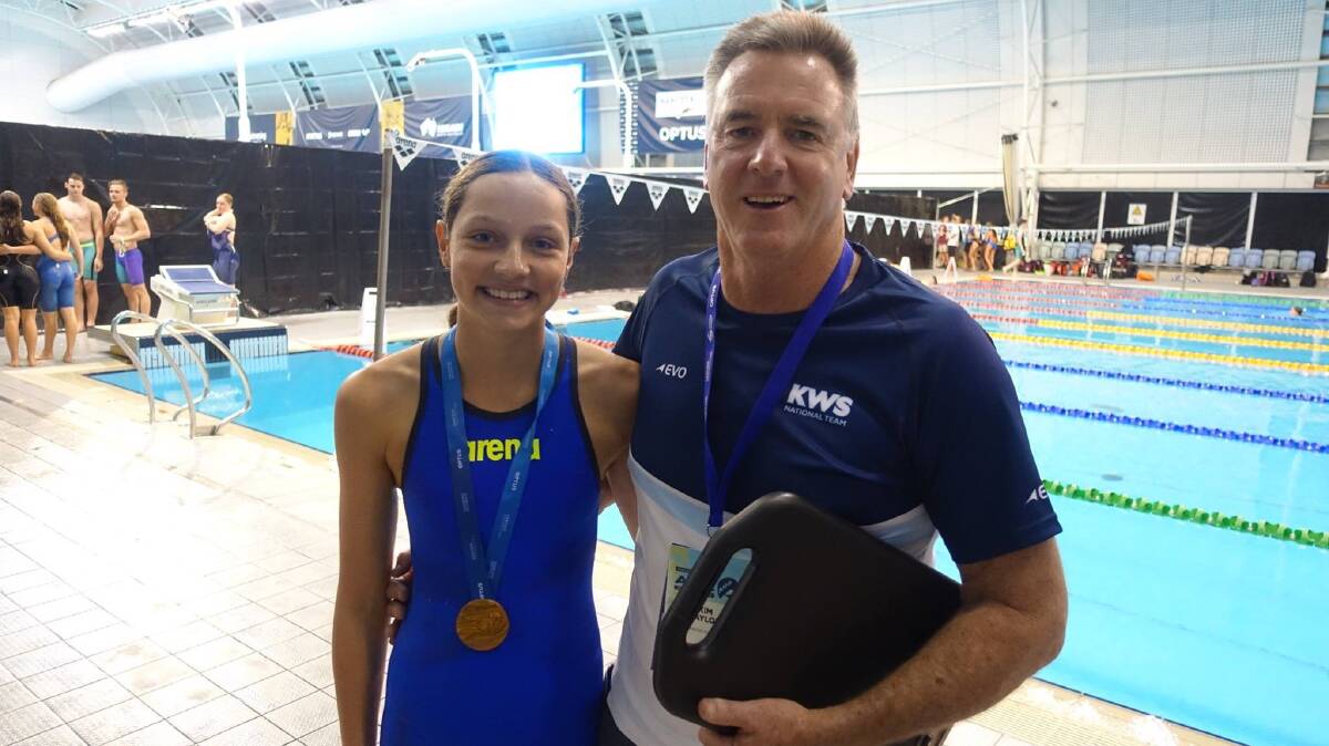 RECORD-SETTER: Collette Lyons and head coach Kim Taylor after winning the 400-metre medley and setting a new NSW record. Photo: SUPPLIED