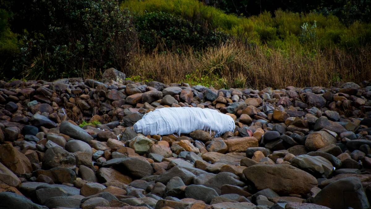 Hazard: A roll of fabric washed ashore at Boulder Bay this week. The shipping container came to rest on rocks a short distance away.  Picture Simon McCarthy